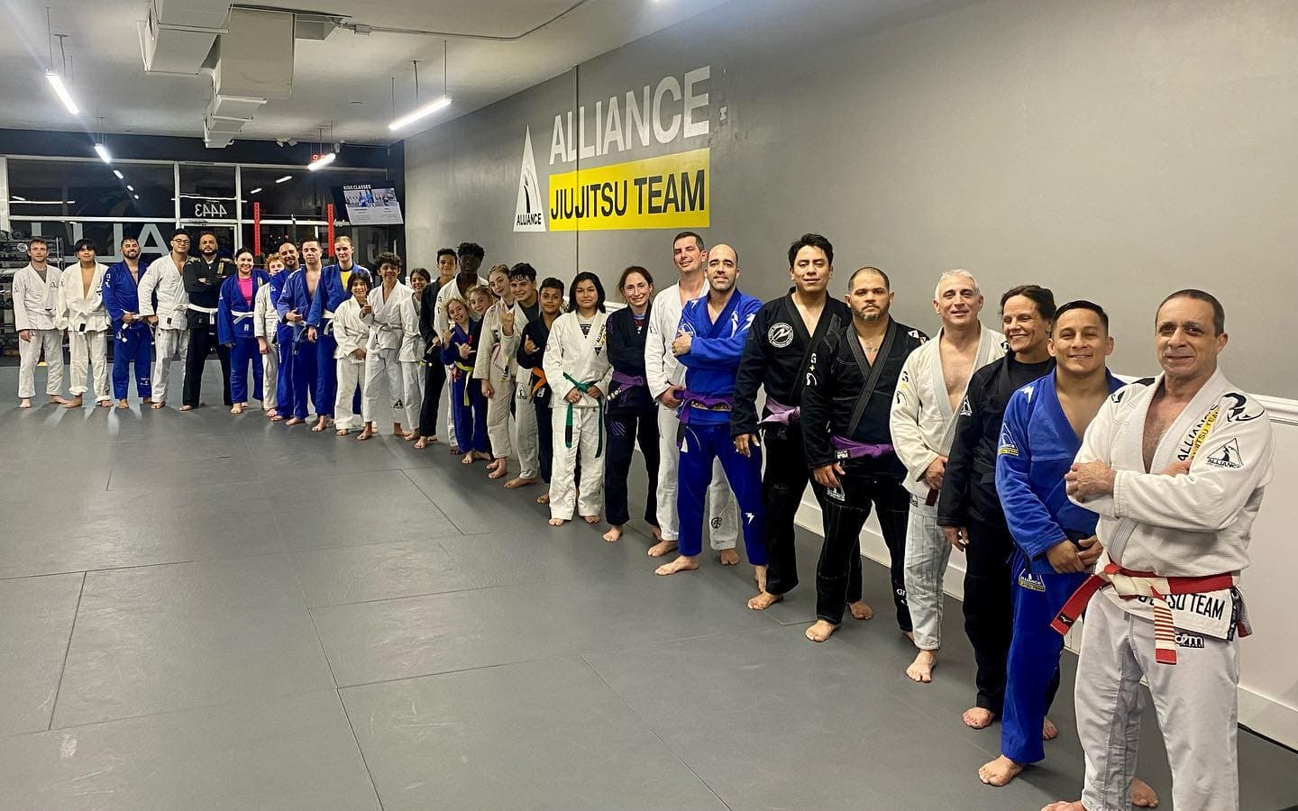 The Brazilian Jiu Jitsu team at Rollyson BJJ in Hollywood, Florida, lined up in their gis