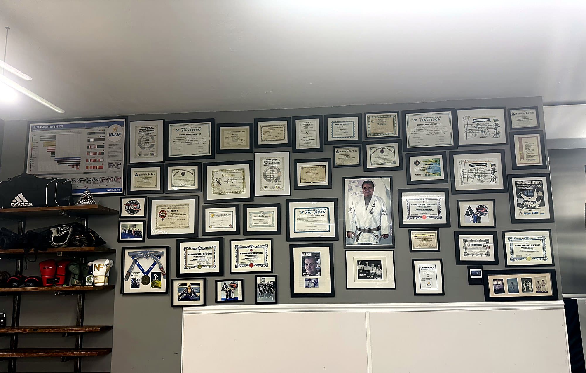 Wall of certificates and lineage photos at Rollyson Brazilian Jiu Jitsu