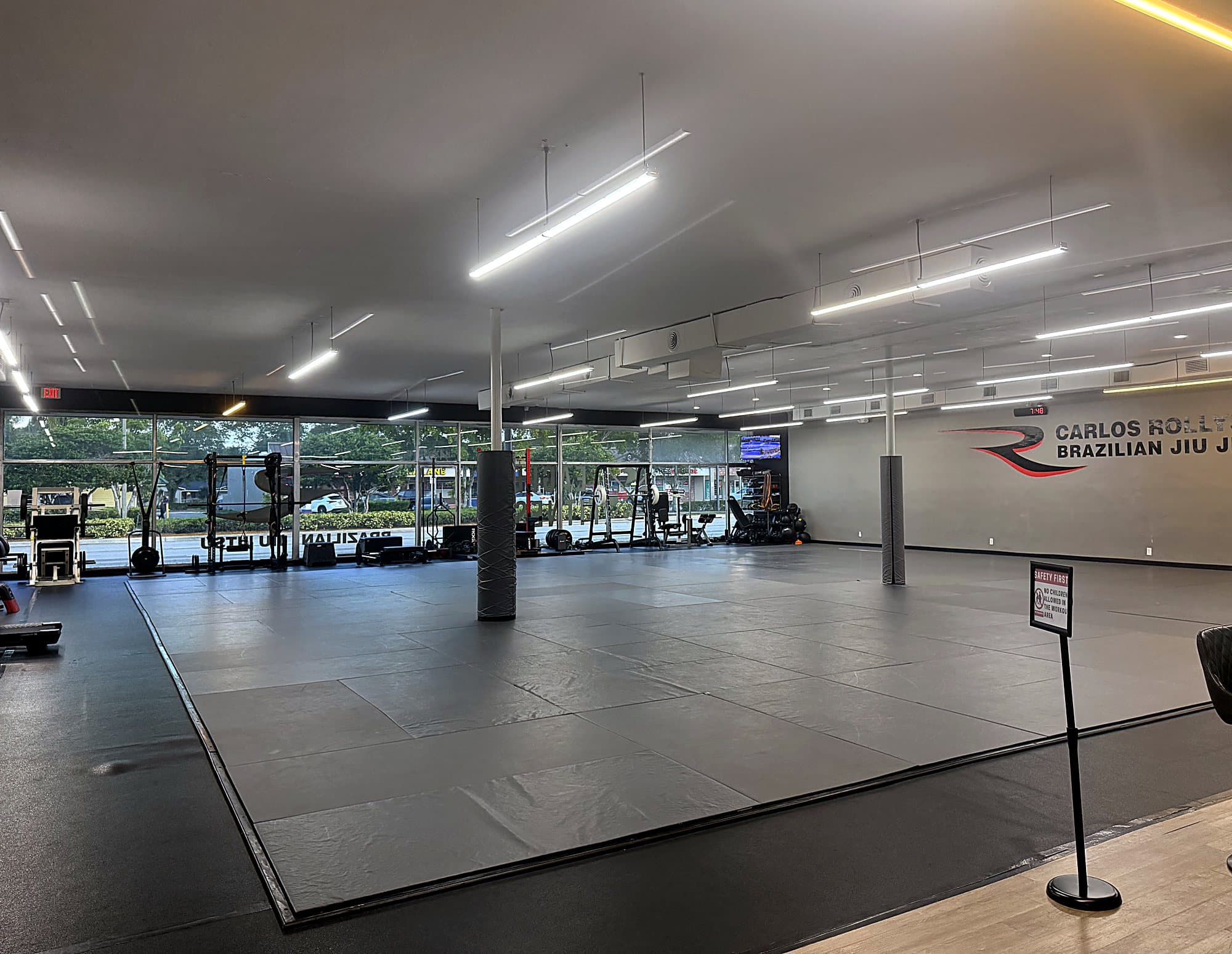 The main mat room at Rollyson Brazilian Jiu Jitsu with floor-to-ceiling windows