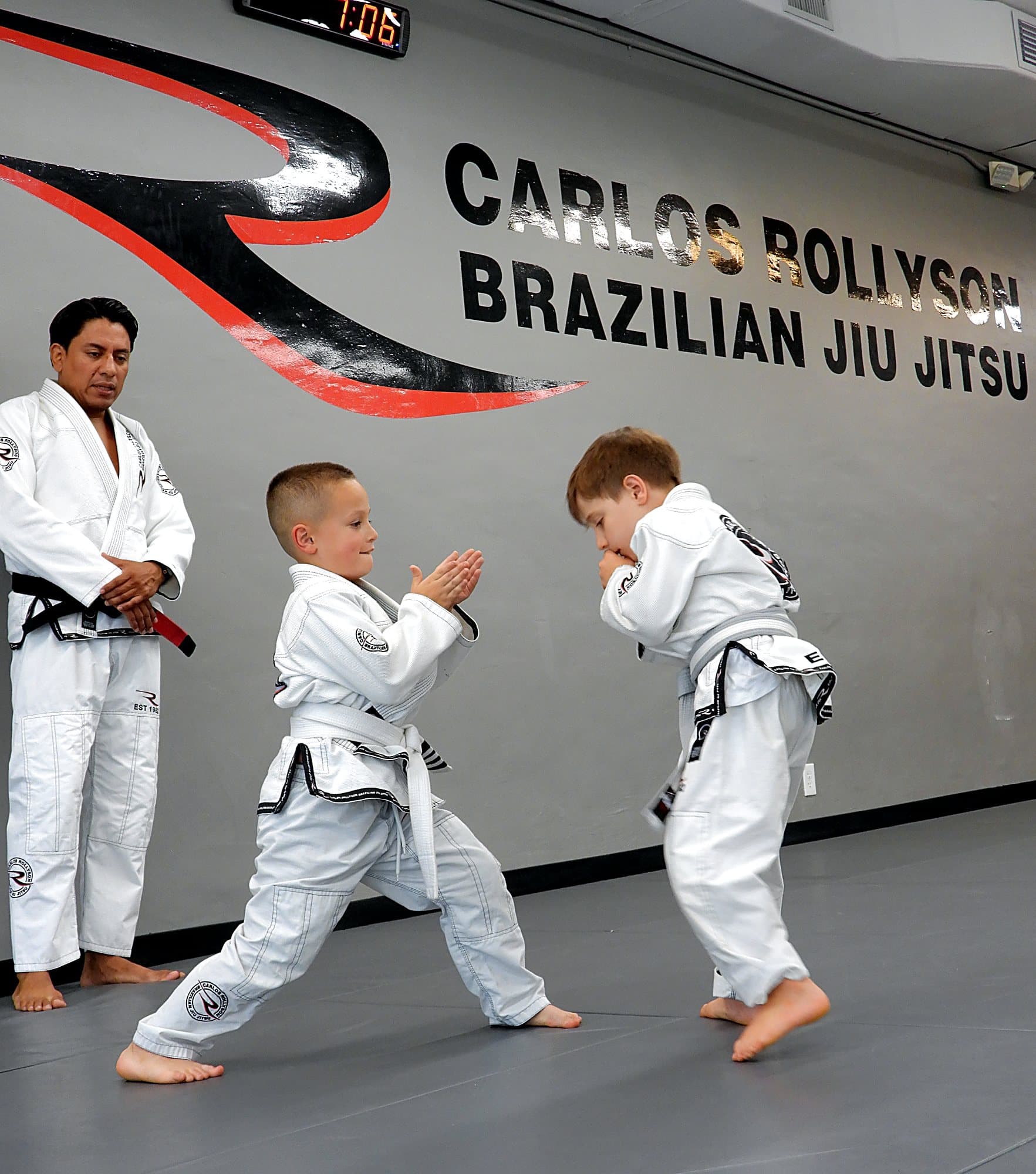 Instructor watching two kids drill a technique