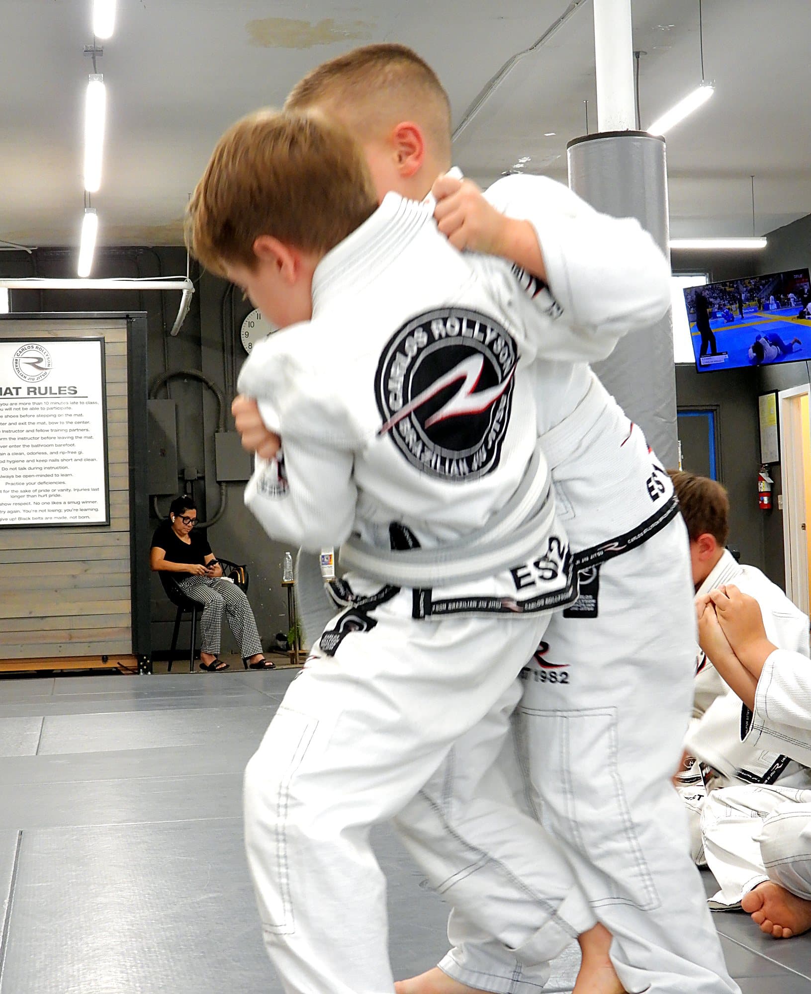 Kids grip fighting in gis during a Young Warriors class