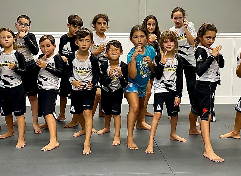 Kids Young Warriors Brazilian Jiu Jitsu class lined up at Rollyson BJJ in Hollywood, FL