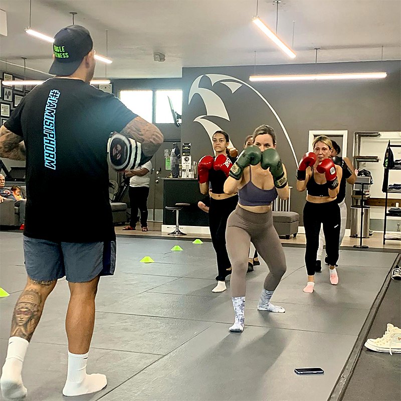 Vic’s striking class working pads and boxing gloves at Eagle Fitness